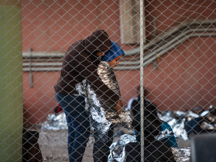 Migrants are given emergency blankets to stay warm.