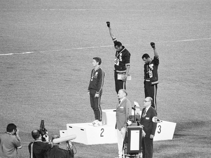 1968: After African-American athletes, Tommie Smith and John Carlos, won gold and bronze medals in the 200-meter run at the Olympic Games, they raised their fists while on the awards podium in a Black Power salute during the National Anthem in a protest against racial discrimination in the United States.