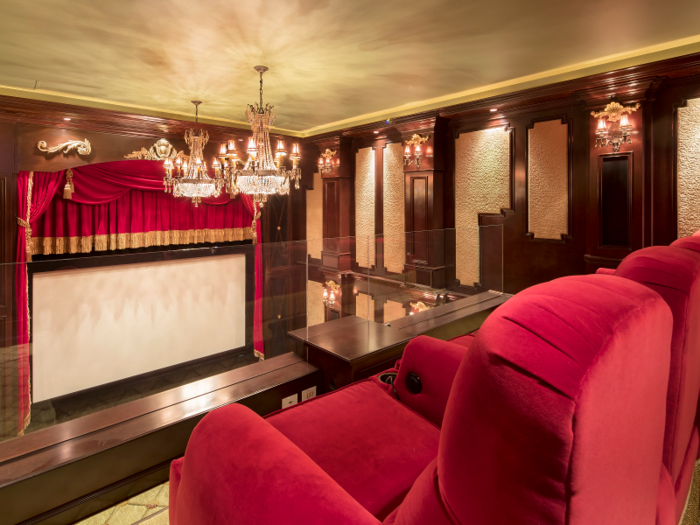 The movie theater spans two levels and includes 12 plush, red velvet chairs.