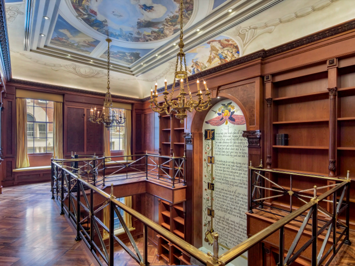 A hidden door off the main hallway leads to the double-height library and office with 24-foot ceilings.