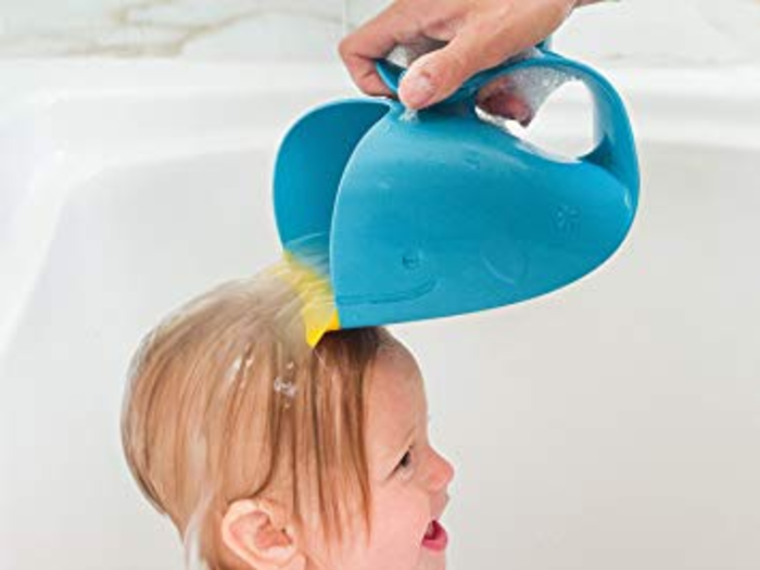 A cute bath cup and spout that helps make bath time easier