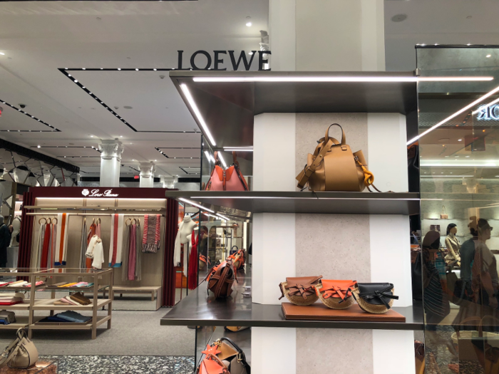 In the center, there were tables and cases featuring accessories from other brands like Loewe, ...