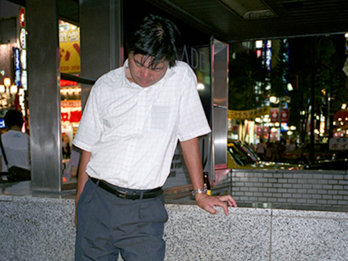 In the wee hours of the night, he noticed men dressed in business suits fast asleep on the streets of Tokyo.