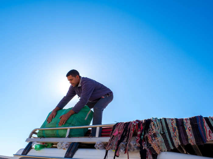 With the sun rising high into the sky, it was time to pack up the tent. We gathered the rugs, sleeping bags, and canvas and bundled it all up on top of the SUV, then raced back out of the desert.