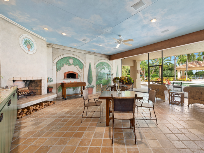 Downstairs, an Italian-inspired dining area includes a wood-fire pizza oven and glass-paneled doors ...