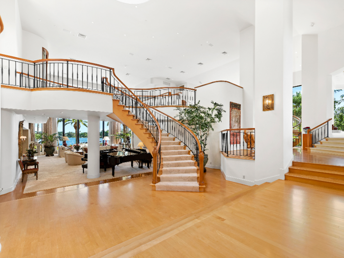 Part of the main level is covered in light-paneled wood flooring ...