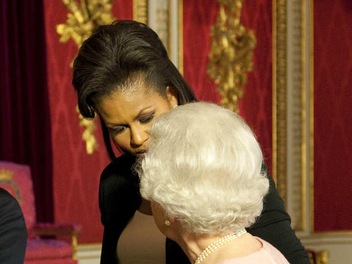 In her memoir "Becoming," Michelle Obama described accidentally violating royal protocol by putting her arm around the queen as a show of affection and support, but says Her Majesty didn