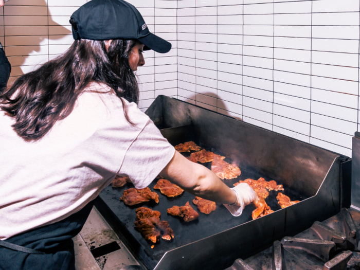 The chicken thighs come to each Chipotle restaurant pre-marinated from a distribution center. Each piece of dark meat gets placed flat-side-down on the grill a few inches away from one another.