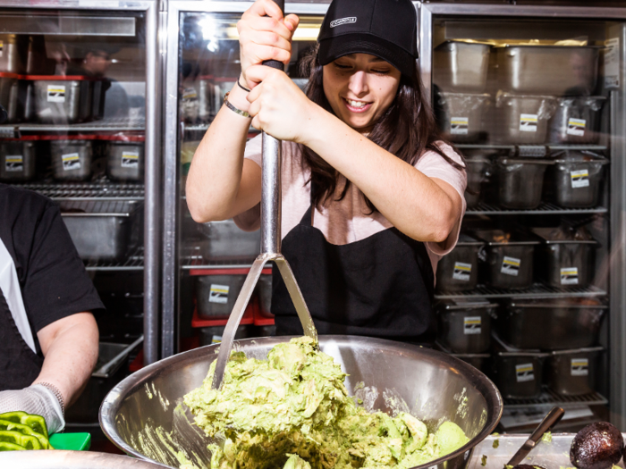 After one case-worth of avocados are de-cloaked and in a bowl, the mashing commences. A team member brought out what looked like the largest potato masher I