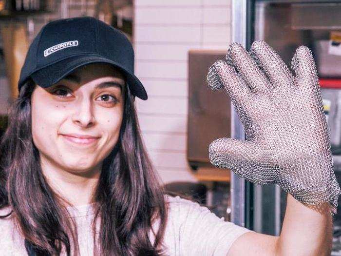 Before any cutting takes place, the employee needs to make sure all safety measures are in place. A chain mail cutting glove like this one is mandated by corporate to prevent accidentally sliced hands — knives used at the restaurant won