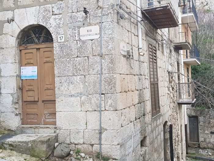 Many of the homes have wooden doors and stone facades.