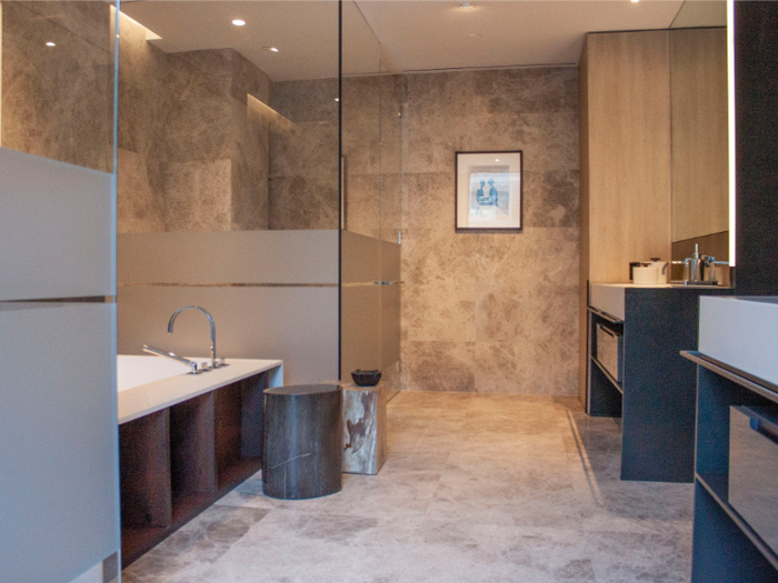 The master bathroom, with Perlado beige marble walls and marble radiant heat flooring, comes with a freestanding bathtub and custom-designed vanities.