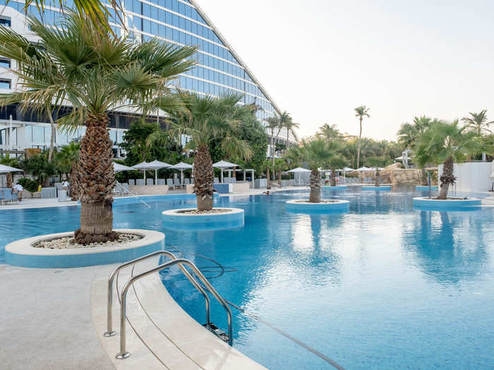 The main pool at the Jumeirah Beach Hotel is spacious, dotted with palm trees, and features a swim-up bar. It