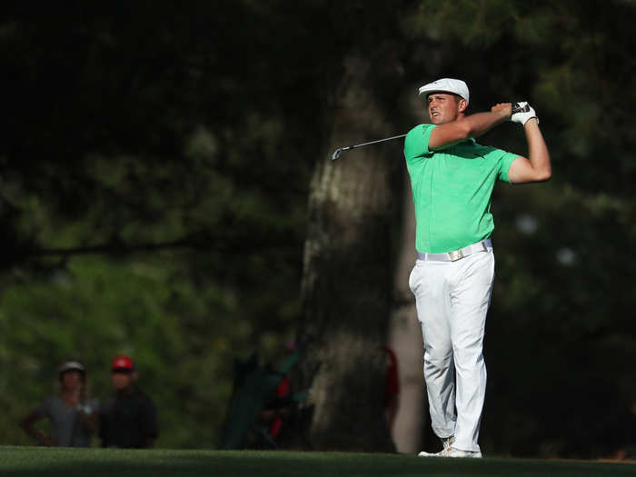 Bryson DeChambeau watches his ball in the late-afternoon sun.