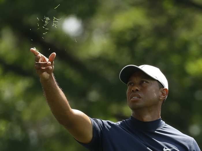 Tiger Woods checks the wind.