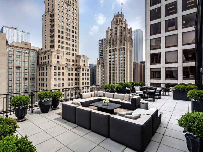 Normally, the large deck includes plenty of outdoor couch seating, though furniture is rearranged to make room for the tent. The terrace also features a fire pit.