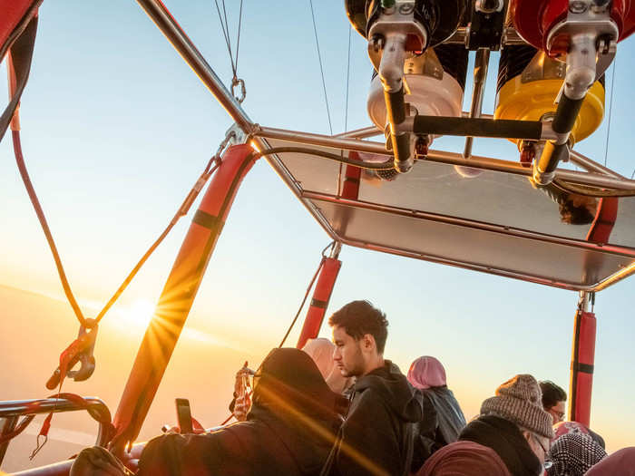 The sun peeked out over the horizon as we floated above the fields of sugarcane, sporadic date palms, and reeds that distinguish the farming villages that surround Luxor.