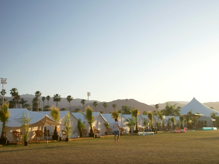 The tents are neatly arranged around an open, grassy area.