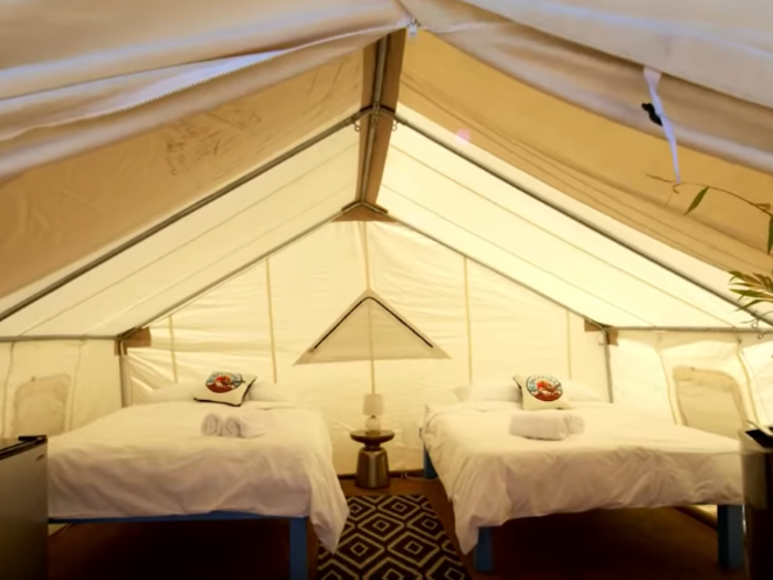 The tents are spacious, come fully furnished, and include a small refrigerator and air conditioner.