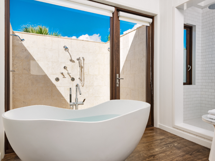 Bathrooms include minimalist, freestanding bathtubs, and one also has an outdoor shower.