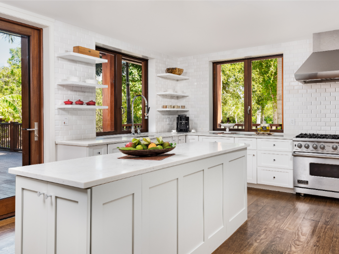 The modern kitchen offers new appliances and clean, white countertops.