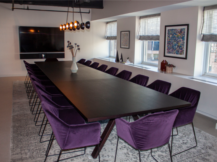 A conference room provides a private space for larger group meetings at the club.