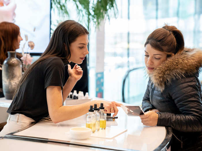 The first floor is filled with booths offering food or drink samples. One station even allows people to make their own face oil.