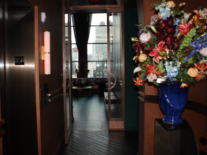 After a quick tour, we took the elevator to the top floor. Upon exiting, I stood in a small hallway decorated with a massive bouquet — a hint of the hotel