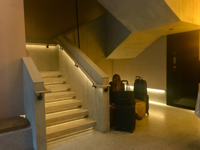 The rest of the lobby, meanwhile, was modern and stark — almost to the point of feeling subterranean. Hotel staff waited for guests behind a modern, floating check-in desk, and a bare, cement-walled stairway led upstairs.