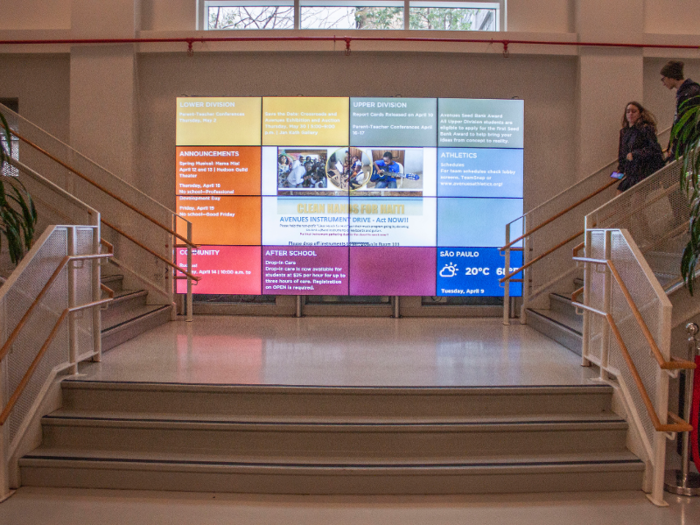 A collection of TV screens displayed school announcements, events, and the weather in Sao Paulo, the school