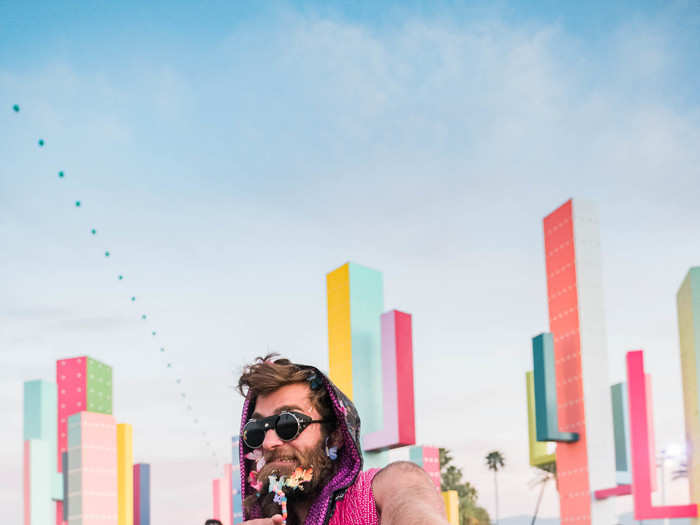 Grant Garcia, a 24-year-old working in sales for a tech company in Los Angeles, spent around $150 on his shorts, glasses, and various scarves, but he said the best part of his outfit was free — the butterflies and beads tied into his beard.