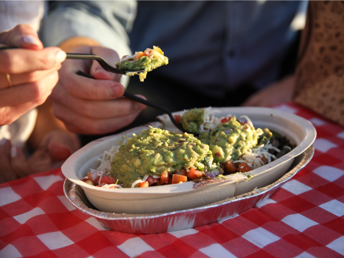 While the default ingredients in the vegetarian bowl are fajita veggies, brown rice, pinto beans, guacamole, tomato salsa, roasted chili-corn salsa, and sour cream, we changed up the pinto beans for black beans, nixed the corn salsa, and added cheese to our vegetarian bowl.