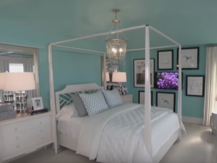 The vibrant colors continue upstairs in the teal master suite.