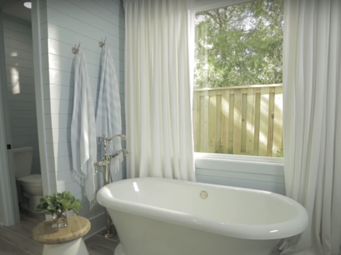 The serene master bathroom has a freestanding tub and a walk-in shower.