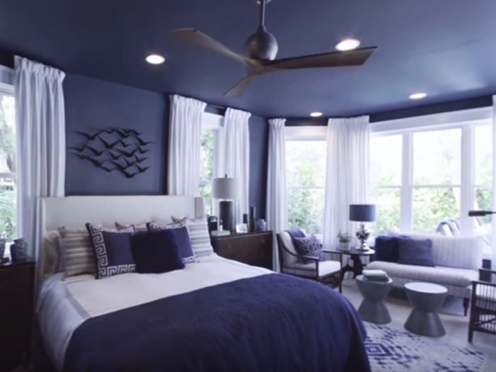 Down the hall from the kitchen, you will find a navy blue master bedroom.