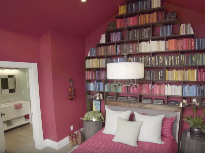 Upstairs there are guest bedrooms, like this one that uses bookshelves as the headboard.