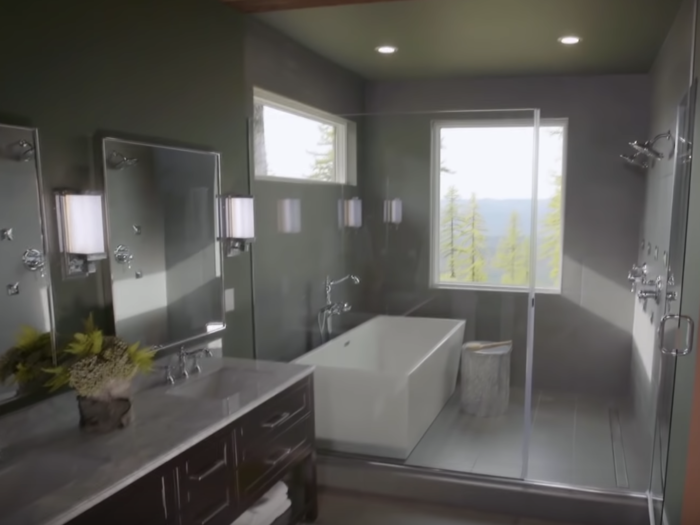 The master bedroom leads into the bathroom, which has a tub inside the walk-in shower.