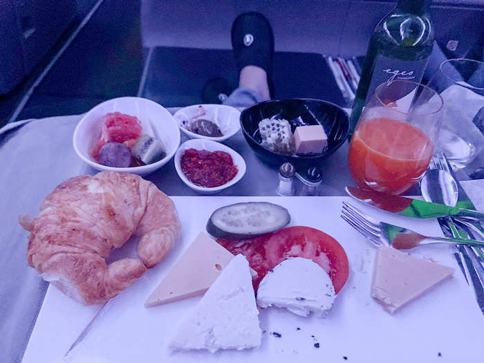 My flight took off in the middle of the night, so our meal was breakfast. It started with goat cheese, a croissant, veggies, and variety of sides like comb honey, countryside butter, marinated olives, and a sun-dried tomato spread — all sourced from Turkish farms.