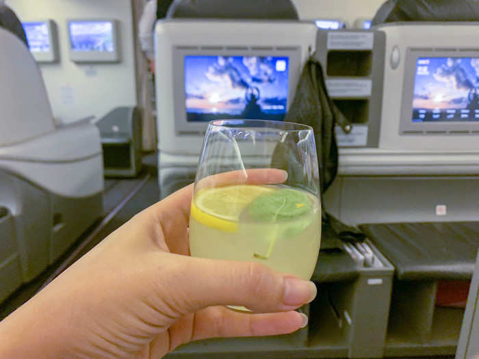 Thankfully, I was able to snag an aisle seat despite being upgraded to business class last minute. Before takeoff, a flight attendant offered drinks. I appreciated that they had a tasty non-alcoholic option like a lemon-mint juice.