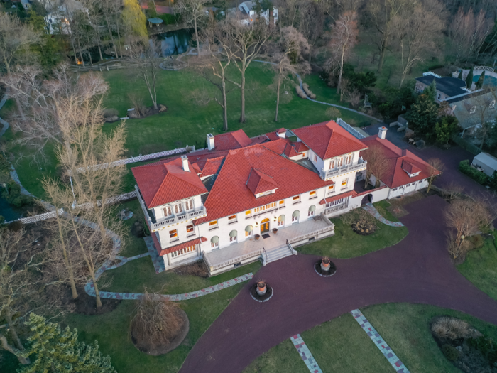 The mansion — nicknamed the "White House of Englewood" sits on more than five acres of private property, which includes manicured lawns, orchards, well-groomed gardens, and a small lake.