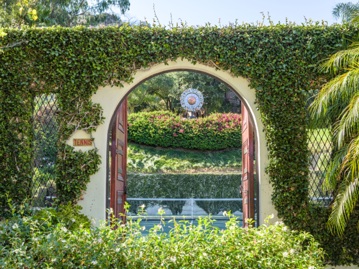 Rustic doors, which match the main gate, lead to other areas of the garden and the expansive property ...