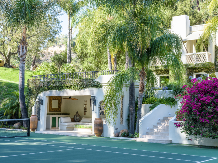 A finished cabana provides a shaded area for guests to cool off after playing tennis in the Californian sun.