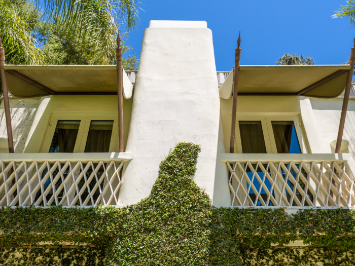 Its ivy-covered front also features several private balconies. Nearby, a 7,000-square-foot guest house can house additional visitors.