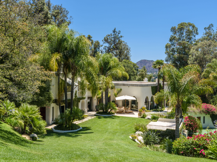 The main house — which is 20,000 square feet — sits on a sloped lawn ...