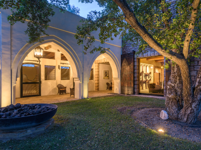 The stables, which are surrounded by manicured lawns, also include a nearby fire pit for outdoor entertaining.