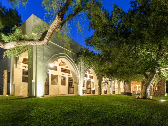 ... which include the stables, marked by arched entryways.