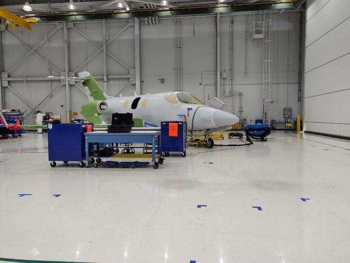 A nearly completed aircraft emerges at the end of the production line.