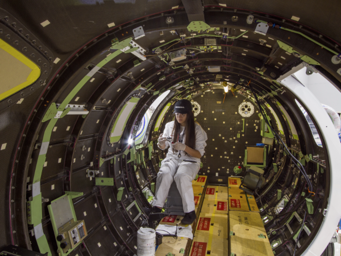 Work is also conducted on the inside of the carbon composite fuselage.