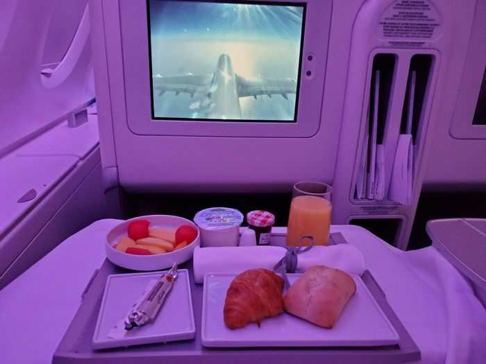 Before I knew it, breakfast was served. The croissant was warm while the fruit salad and juice tasted fresh. I always struggle with wanting to eat breakfast on overnight flights when my body thinks it