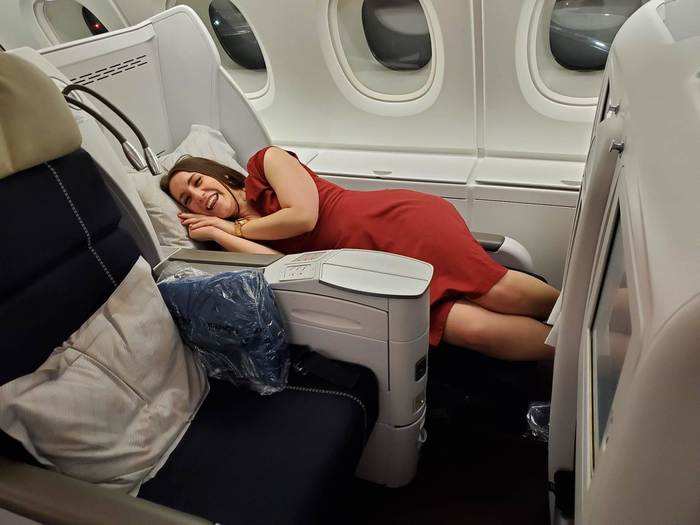 You can lie almost flat. During the night, I found myself slipping down toward the footrest a few times. That and the turbulence interrupted my sleep a few times.